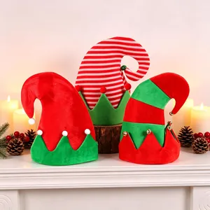 Three festive red and green plush elf hats with golden bells for Christmas holiday decor