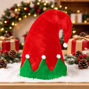 Red and green patchwork elf Christmas hat with white pom-poms in a festive holiday scene.