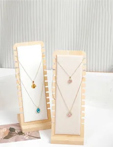 Detail view of bamboo wooden necklace display stands with multiple slots for jewelry