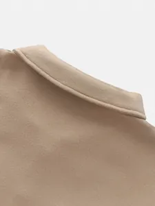 Close-up of the lapel collar on a beige wool coat showing premium fabric texture