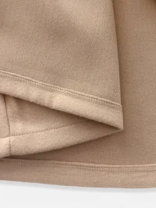 Detailed view of the soft fleece lining and high-quality stitching on a camel jacket.