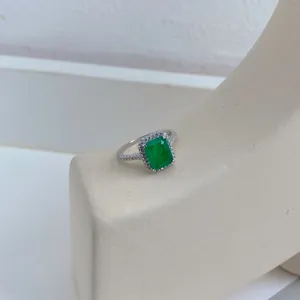 Close-up of emerald cut green zircon ring set in S925 sterling silver with halo