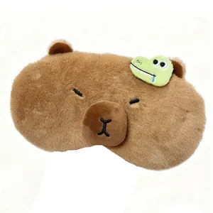Cute brown plush Capybara sleep mask with small crocodile detail on a clean white background
