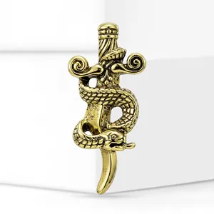 Detailed view of a vintage gold alloy snake coiled around a sword brooch pin