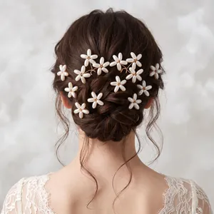 Detailed view of elegant handmade pearl flower hair pins in a bridal updo.