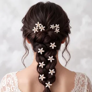 Detail shot of pearl flower hair pins elegantly styled in a bridal braid hairstyle.