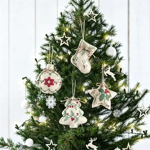 Set of rustic linen Christmas ornaments including stocking, star, tree and ball shapes