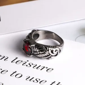 Vintage gothic silver wing ring featuring a large round red gemstone for punk fashion