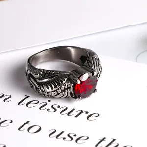 Vintage silver wings ring featuring a vibrant faceted red gemstone centerpiece design