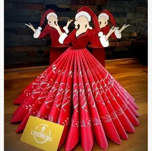 Detailed view of creative wooden Christmas napkin holder with elegant red dress