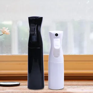 Side detail view of black and white continuous fine mist spray bottles on a wooden windowsill