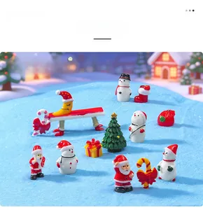 Close-up of miniature Christmas resin ornaments featuring Santa, snowman and tree