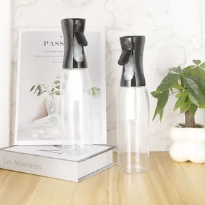 Fine mist spray bottles for beauty and cleaning displayed with props on a wooden table