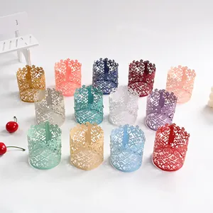 Colorful hollow paper lampshades featuring intricate floral laser-cut patterns.