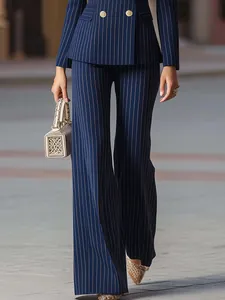 Close-up detail of navy blue pinstriped business suit with wide-leg trousers for women