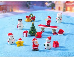 Detailed view of assorted Christmas resin miniature figurines on a blue snowy surface