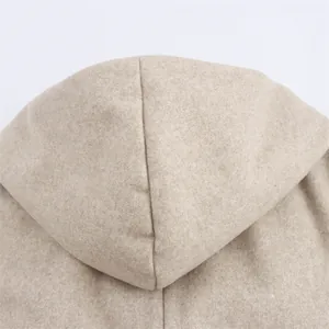 Macro detail showing the soft textured hood on a solid color wool-like coat for women