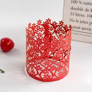 Detail view of red hollowed-out paper lampshade with delicate floral and heart cutout patterns