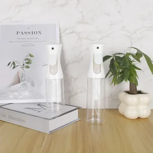 Close-up detailed view of two white continuous fine mist spray bottles on a wooden desk