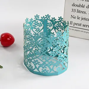 Close-up detail of a teal laser-cut paper lampshade with delicate hollow floral patterns