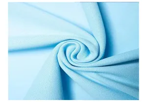 Close-up detail of light blue piqué fabric showing breathable texture and weave