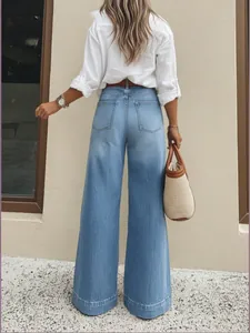 Back view of stylish high-waisted light blue wide-leg jeans with vintage wash finish