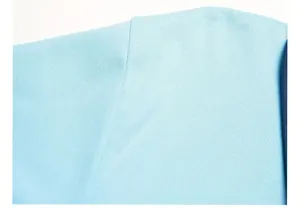 Close-up of light blue pique polo shirt shoulder seam and fine mesh fabric texture