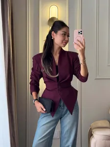Detailed view of the burgundy slim fit waist V-neck designer blazer on a model