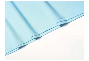 Detail shot of light blue polo shirt hem showing high-quality pique fabric texture