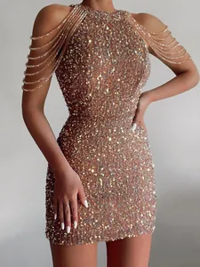 Detailed view of elegant sequin mini dress featuring sparkling crystal shoulder tassels
