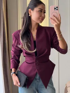 Detailed view of a stylish burgundy slim-fit peplum blazer with button waist accents
