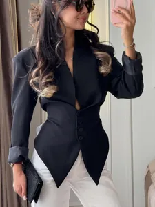 Detail view of a slim-fit black blazer with a cinched waist and V-neck design.