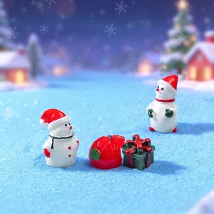 Miniature resin Christmas figurine set with snowmen and gift boxes in a snowy scene