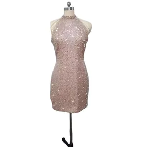 Elegant rose gold halter neck sequin mini dress with crystal fringe on white mannequin