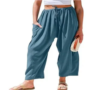 Detail of loose fit cotton linen pants with elastic drawstring waist and side pockets.
