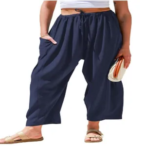 Close-up view of navy blue loose cotton linen trousers featuring an elastic drawstring waist