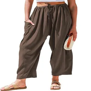 Detailed shot of brown elastic waist cotton linen cropped pants worn by a model