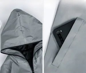 Detail view of grey reflective outdoor jacket showing hood design and functional side pocket