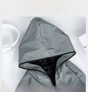 Detailed view of grey reflective hooded outdoor windbreaker jacket with front zipper.