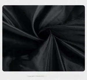 Macro view of the smooth texture and subtle sheen of the premium black jacket lining fabric