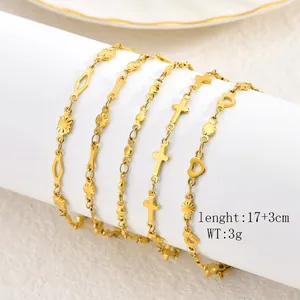 Close-up of elegant gold stainless steel bracelets with heart and cross charms for fashion