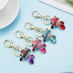 Detailed view of colorful rhinestone goldfish keychains in red, blue, pink and purple