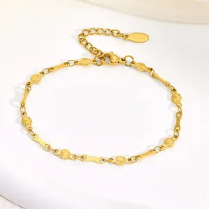 Close-up of gold stainless steel bracelet with sunburst links and S.steel tag
