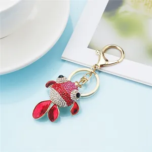 Close-up of cute goldfish keychain charm with sparkling red and white rhinestones