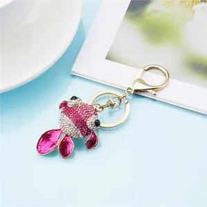 Detailed view of goldfish keychain with sparkling pink and white rhinestones