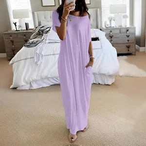 Casual short sleeve light purple maxi dress with pockets shown in a cozy bedroom setting.