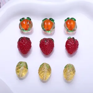 Macro detail of various miniature colorful glass fruit beads for DIY jewelry making projects