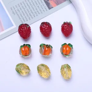 Detailed macro shot of assorted fruit-shaped glass beads for DIY jewelry making.