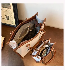 Internal view of large capacity canvas tote bags showing multiple compartments