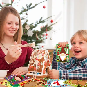 Children decorating gingerbread house using colorful DIY Christmas cartoon puzzle stickers